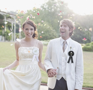 Close-up of black and white wedding ribbon badges with gold Bride and Groom text