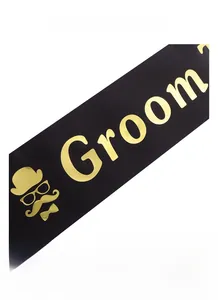 Detail of black satin Groom sash with gold foil lettering and gentleman icons