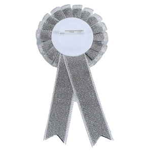 Close-up of bride badge back featuring a safety pin and white plastic base with ribbons