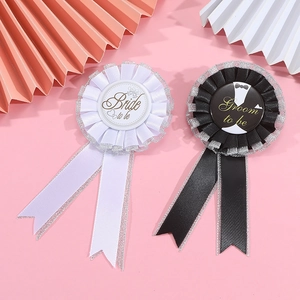 Detail of Groom and Bride to be badges with lace trim for bachelor party decoration
