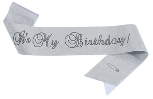 Detail of silver glitter birthday sash with black It's My Birthday text and pin