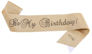 Detail of gold glitter birthday queen sash with black rhinestones and safety pin