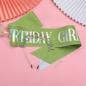 Détail d'une écharpe Birthday Girl à paillettes vertes et diadème sur fond rose