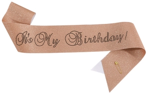 Macro detail of rose gold glitter birthday sash with black It's My Birthday text