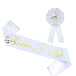 Detail of Bride To Be white satin sash and matching lace ribbon badge with gold foil lettering
