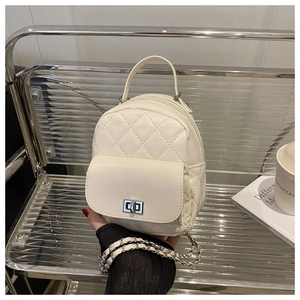 Detail of cream quilted mini backpack with metal turn-lock and chain strap textures