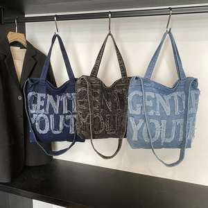 Denim canvas tote bags in blue and grey with Gentle Youth lettering for women