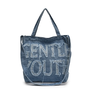 Denim canvas tote bag with Gentle Youth lettering and frayed edges for street style