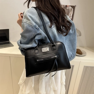 Modische schwarze Leder-Schultertasche mit Metallplatte und langen Reißverschluss-Zierstreifen