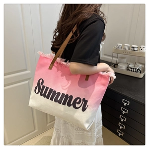Close-up of pink gradient canvas tote bag with Summer print and fringe details