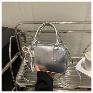 Silver mirror leather Boston bag with pearl bow charm and crossbody strap