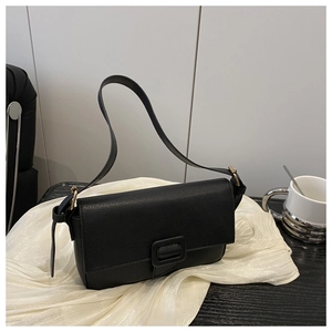 Close-up of black litchi texture leather shoulder bag with square buckle detail