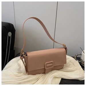 Detail of nude pink shoulder bag featuring lychee grain leather and square buckle