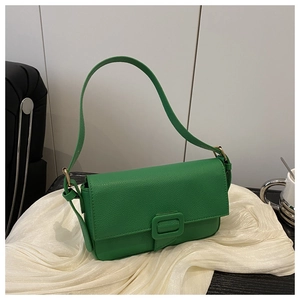 Detailed view of green crossbody bag with litchi grain texture and square buckle
