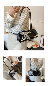 Detail of black patent leather baguette bag with pearl chain and lace bow decorations