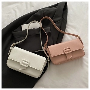 Detail of lychee textured leather shoulder bags in beige and pink with square buckle