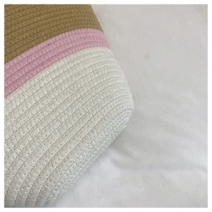 Close-up of the thick cotton rope weaving texture on the striped straw tote bag