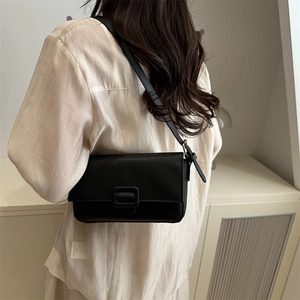 Minimalist black lychee leather crossbody bag with flap and decorative square buckle
