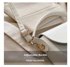 Close-up of adjustable light gold buckle and silver glitter splicing on white saddle bag