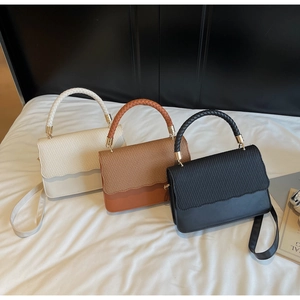 Detail of minimalist handbags in three colors with woven texture and wavy edge cut design