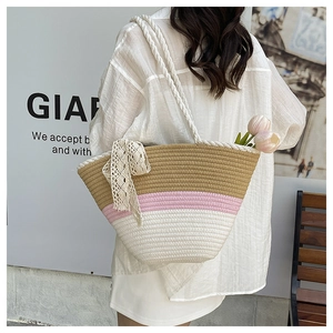 Close-up of tricolor woven tote bag with white lace bow and sturdy knotted rope handles
