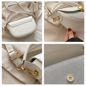 Detail view of white semi-circle saddle bag with silver sequins and gold hardware