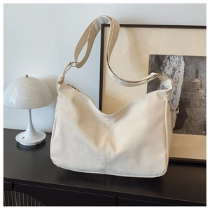 Detail view of large nylon tote bag with smooth texture and adjustable shoulder strap