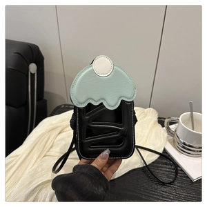 Detailed view of an ice cream shaped crossbody phone bag with mint green flap and black body