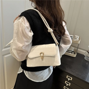 White crocodile pattern underarm bag with gold metal clasp and knotted shoulder strap