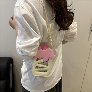 Cute pink cupcake shaped crossbody bag with cream design and hollow stripe patterns