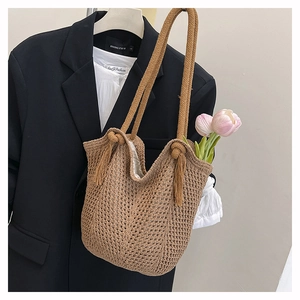 Detail of hollow woven tote bag with side tassels and durable double rope straps