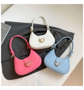 Detail view of crescent handbags with D-shaped metal buckles and knotted handles in multi-colors