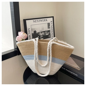 Detailed view of striped woven beach tote with cotton rope handles and three-color texture