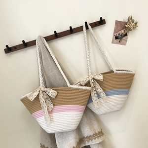 Large woven tote bags with colorful stripes and lace bows for beach holidays