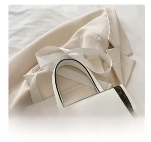 Detail view of the adjustable wide fabric strap and golden buckle on the tote bag