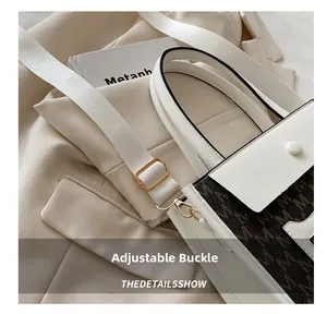 Detail of adjustable nylon shoulder strap and gold-tone metal buckle on tote bag