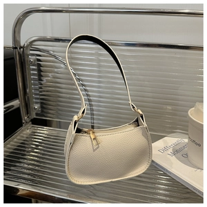 Detail of off-white lychee grain leather hobo bag with high-quality gold metal zipper