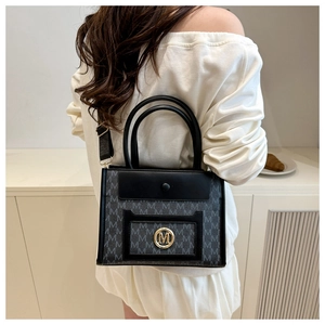 Detail of a chic black and gray拼接 tote with gold M logo and monogram pattern for women
