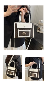 Detail of multi-way tote bag with gold M-logo ring and textured monogram stitching