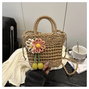 Close-up of woven bucket bag with crochet flower accents and drawstring closure detail