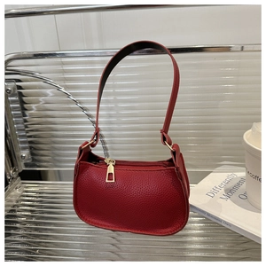 Detail of red pebbled leather small square bag with luxury gold zipper and moon shape
