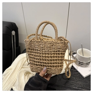 Detail of woven floral straw bucket bag with drawstring liner and openwork texture