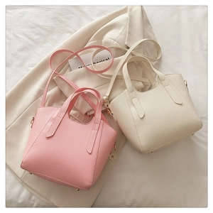 Detail view of pink and beige lychee pattern tote bags with handles and shoulder straps