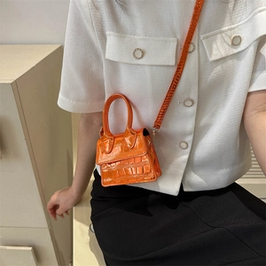 Mini orange faux crocodile leather handbag with glossy finish and detachable crossbody strap