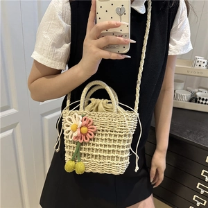 Handwoven straw crossbody bag with floral crochet details and drawstring lining for summer