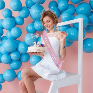 Pink birthday set including glitter sash, alloy tiara and cake topper on girl model