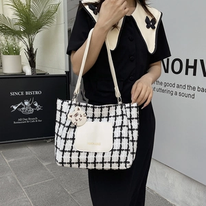 Plaid tweed tote bag with PU leather pocket and cute cat pendant shown on model