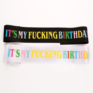 Detail of black and white satin party sashes with colorful It's My Birthday lettering