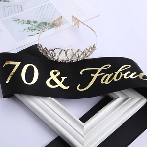 Close-up of a sparkling 70th birthday tiara and black 70 & Fabulous satin sash set