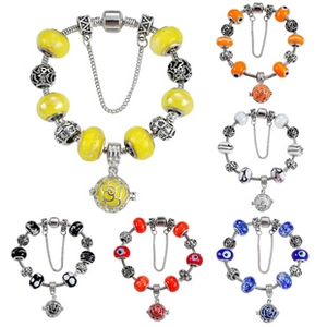 Detailed macro view of hollow flower charms and colorful glass beads on a charm bracelet